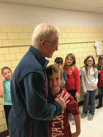 child hugging old man